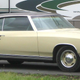 Like this but with rust over the wheelarches, a peeling vinyl top, rusting steelies, and faded orange paint.